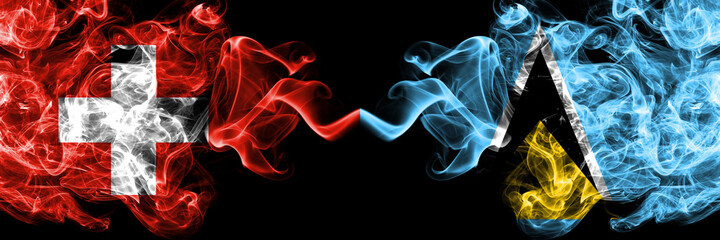 Switzerland, Swiss vs Saint Lucia smoky mystic flags placed side by side. Thick colored silky abstract smoke flags.