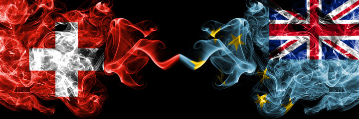 Switzerland, Swiss vs Tuvalu smoky mystic flags placed side by side. Thick colored silky abstract...