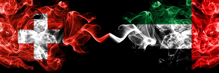 Switzerland, Swiss vs United Arab Emirates, Emirati smoky mystic flags placed side by side. Thick colored silky abstract smoke flags.