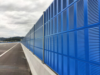 Fototapeta premium SELANGOR, MALAYSIA - JULY 2, 2020: Noise barriers are installed along the vehicle lane bordering the residence to prevent noise pollution to the locals.