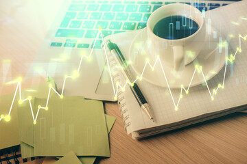 Fototapeta premium Double exposure of forex chart drawing and desktop with coffee and items on table background. Concept of financial market trading