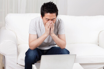 Fototapeta premium Cheerful businessman using a laptop computer in sofa