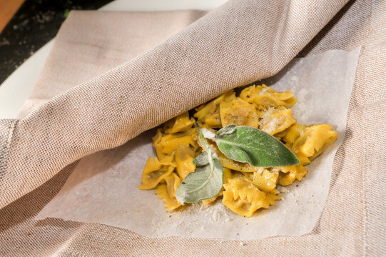 ravioli del plin typical Piedmontese stuffed pasta from the Langhe seasoned with butter and sage and parmesan, traditionally served in a napkin