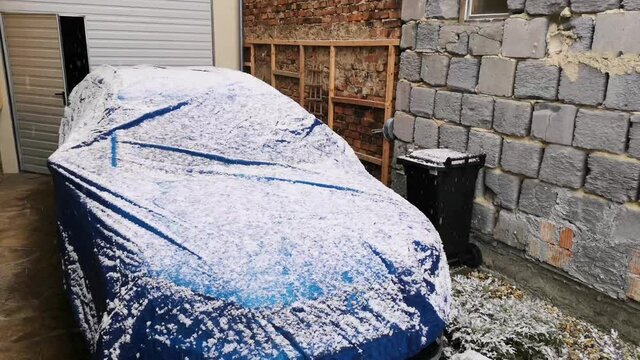 Automobile is covered with a protective cover in winter