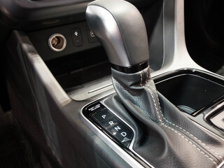 Fototapeta na wymiar Power shift gear inside car interior. Automatic gear stick