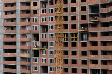 Fototapeta na wymiar Installation of window frames during construction. Energy saving. Production of apartments, social housing.
