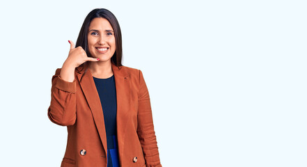 Young beautiful brunette woman wearing elegant clothes smiling doing phone gesture with hand and fingers like talking on the telephone. communicating concepts.