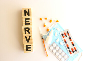 The word NERVE is made of wooden cubes on a white background. Medical concept.