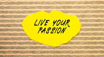 Yellow torn paper with the text LIVE YOUR PASSION on a gray-pink background.