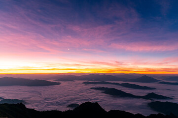 Landscape and starscape of the mountain and sea of mist in winter sunrise view from top of Doi Pha Tang mountain , Chiang Rai, Thailand