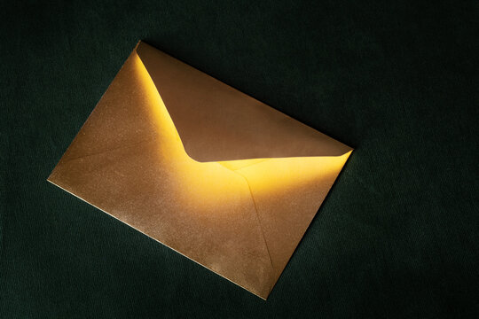 Mysterious golden letter with magic light from the inside