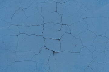 Cracked plaster structure. Background, texture. Neutral blue color.