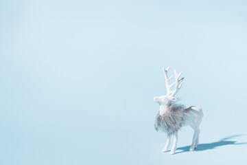 Christmas reindeer on blue background. Minimalistic concept.