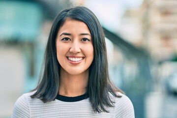 Fototapeta premium Young hispanic woman smiling happy walking at the city.