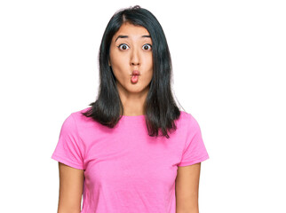 Fototapeta premium Beautiful asian young woman wearing casual pink t shirt making fish face with lips, crazy and comical gesture. funny expression.