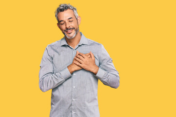 Middle age grey-haired man wearing casual clothes smiling with hands on chest with closed eyes and grateful gesture on face. health concept.