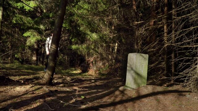 Thurst in the woods near the old border pillar of the Czech-Polish border. Travel concept. Carpathian mountain range. Ukraine. 4K