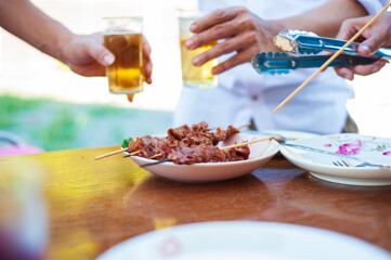 Barbecue steak on a plate at an outdoor party.