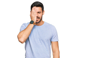 Young hispanic man wearing casual clothes yawning tired covering half face, eye and mouth with hand. face hurts in pain.