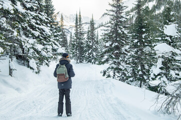 Fototapeta na wymiar Tourist walking on road in winter nature