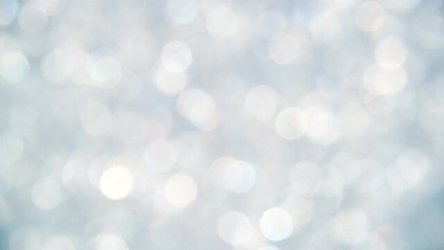 Abstract background of silver bokeh spinning