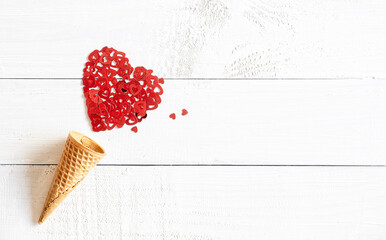 Ice-cream cone on white wooden background with red heart shape decorations,  romantic, Valentines concept, copy space