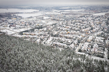 Aerial landscape of small village at the pine forest covered with fresh snow