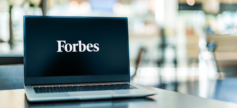 Laptop computer displaying logo of Forbes