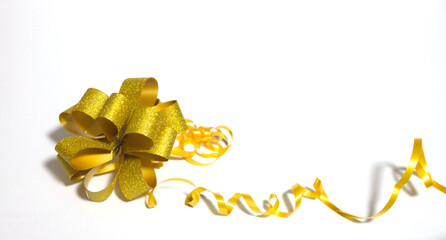 Golden bow with yellow ribbon on a white background. Holidays, Congratulations.
