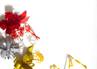 Red, gold and silver bows in the corner on a white background