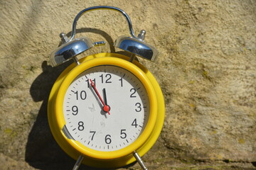 Clock shows five minutes to twelve