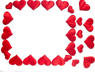A lot of red hearts that lie on a white background. A place for congratulations.