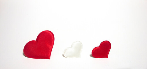 Large and small hearts located on a white background. Valentine's Day