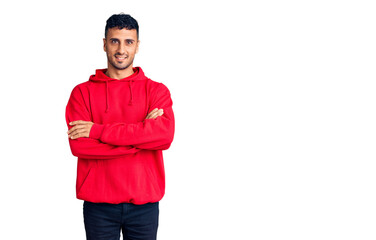 Fototapeta premium Young hispanic man wearing casual clothes happy face smiling with crossed arms looking at the camera. positive person.