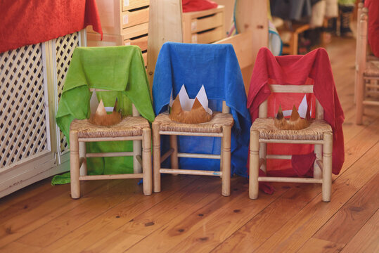 Chairs with three wizarding crowns to play at school.