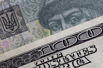 100 dollar banknote on 1 hryvnya banknote