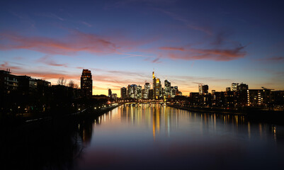 the sun set in Frankfurt am Main look like a new world coming out full of warm light trying to ignore the dark night 