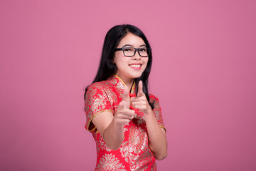 Action portrait beautiful Asian girl wearing Cheongsam red dress. the celebration of something in a joyful and exuberant way. Festivities and Celebration concept