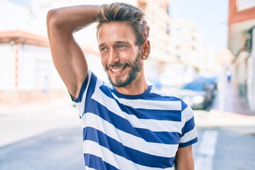 Handsome caucasian man with beard smiling happy outdoors