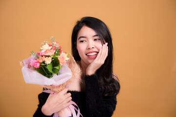 Beauty and healthcare. Portrait of young and beautiful asian woman on ัyellow background