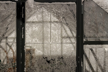 Gorgeous view through frozen window. Beautiful winter background texture. 