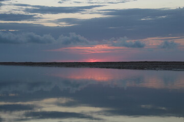 Fototapeta na wymiar pink sunset on the coast of the river