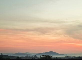 Morning blur over mountains and trees. The first and last light of the day in sky