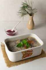 Meat jellied meat with parsley in a traditional dish. Festive dishes. Rustic style.