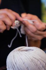 Naklejka premium hand of person making handicrafts of wool and thread weaves dreamcatcher with needle and ball córdoba argentina