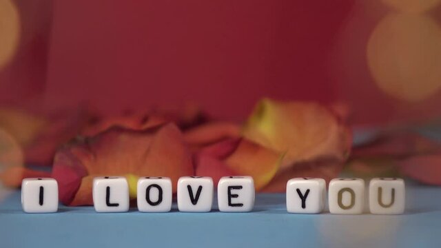 I love you against the background of rose petals . Valentine's Day. Background concept of love and beauty
