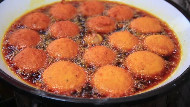 salvador, bahia, brazil - january 8, 2021: acaraje during frying in a pan with palm oil, in downtown Salvador.