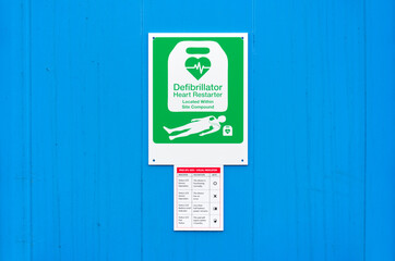 Defibrillator AED sign on wall in public space for emergency heart resuscitation