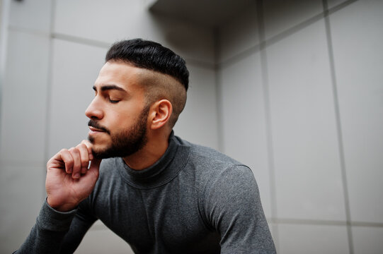 Portrait of stylish arab beard man wear grey turtleneck. Arabian model guy against steel wall.