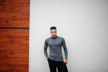 Portrait of stylish arab beard man wear grey turtleneck and black jaket. Arabian model guy.